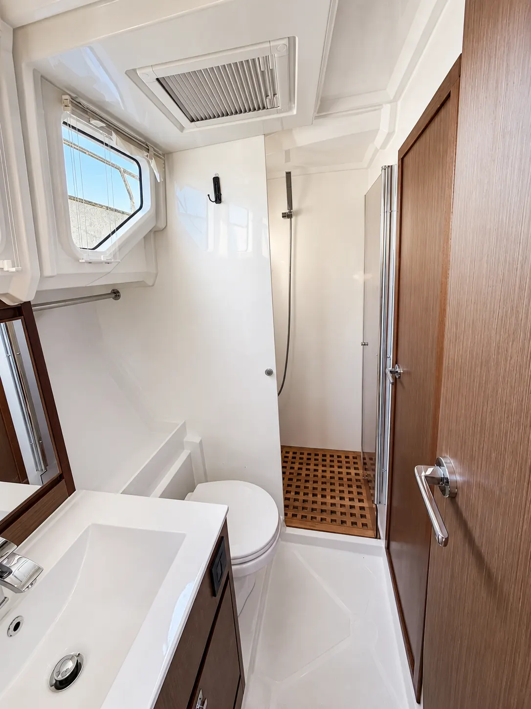Enclosed shower with teak grate aboard the Delphia 12