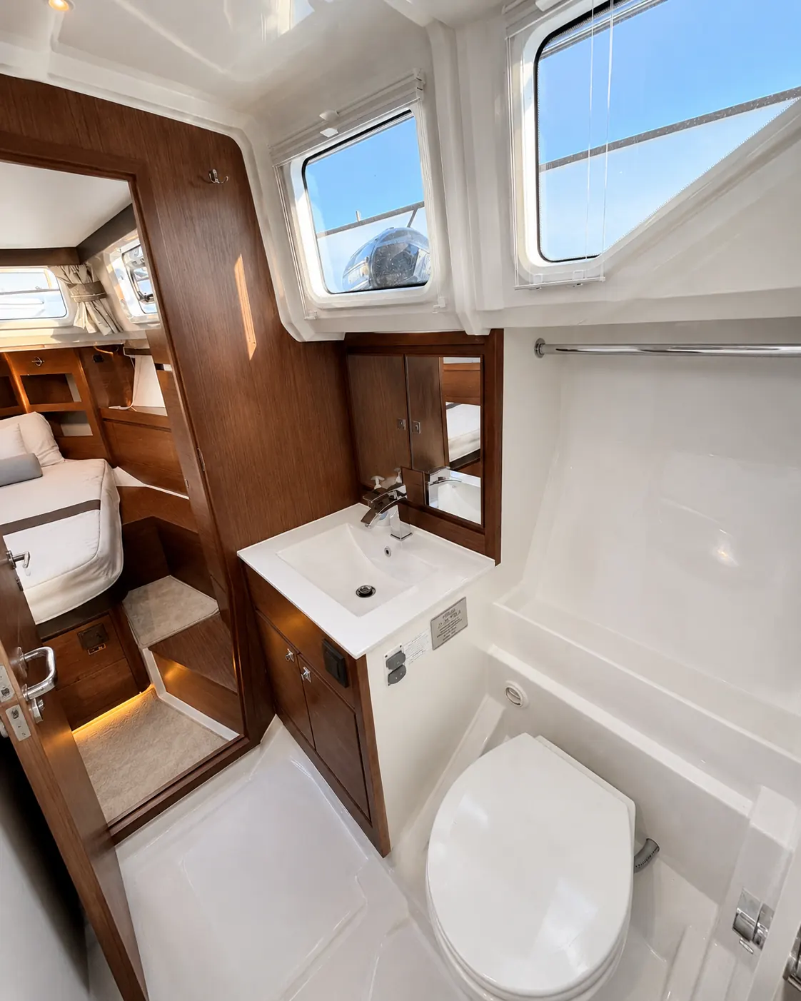 Bright private head with vanity and enclosed shower