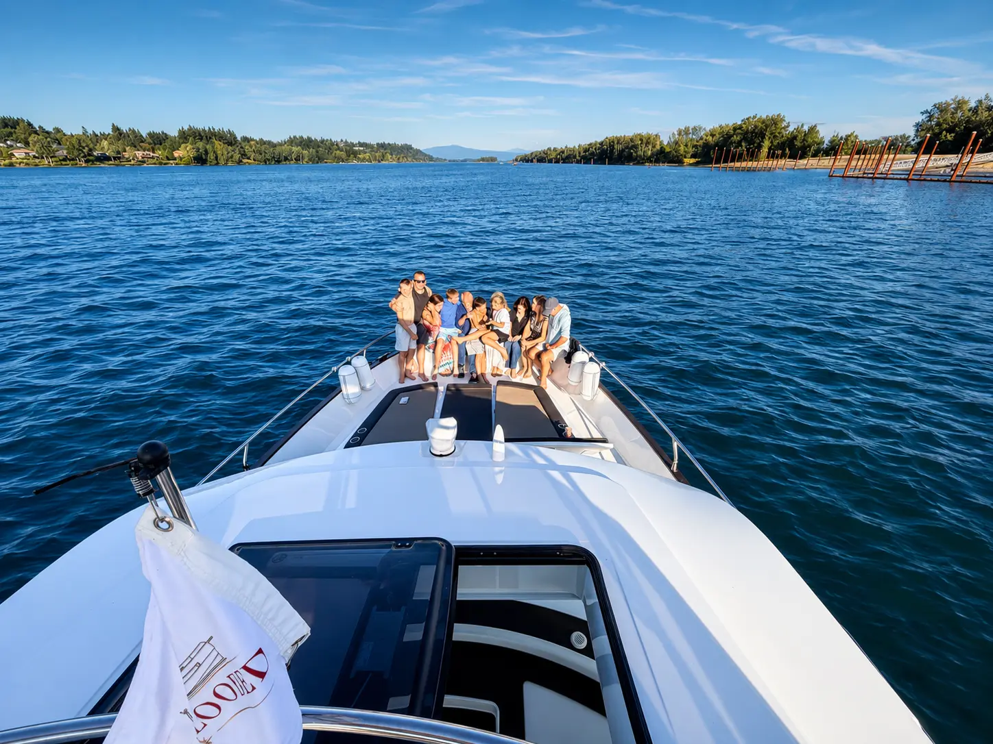 Guests on the bow with a wide river view ahead