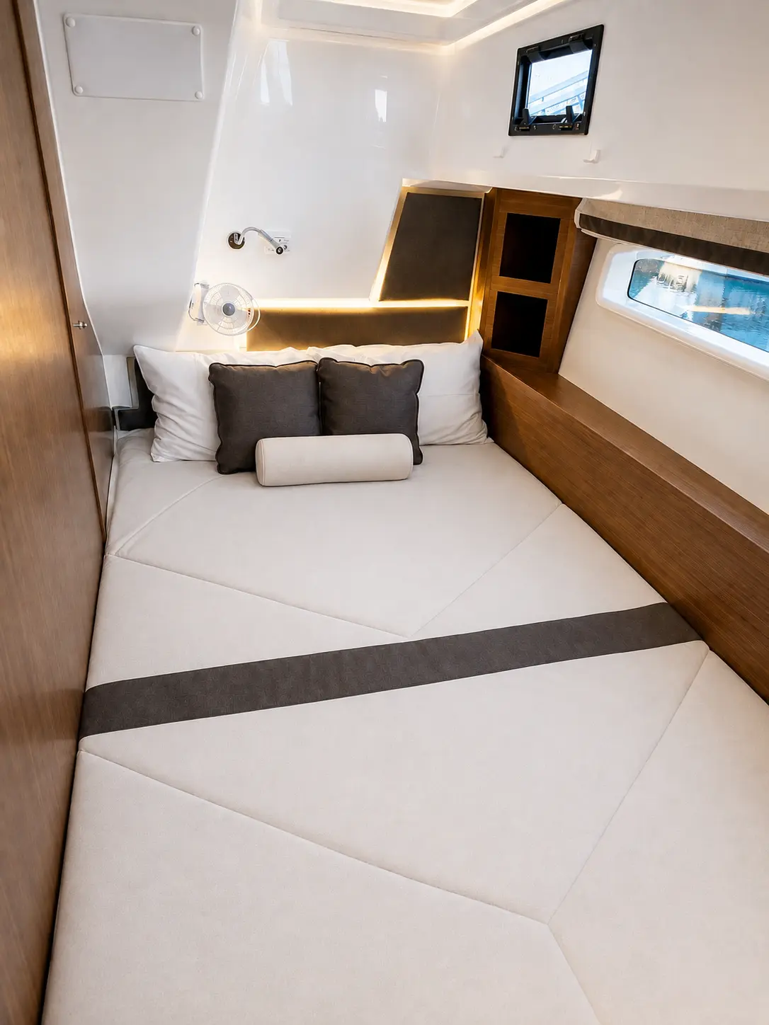 Forward cabin berth with hull window and reading light